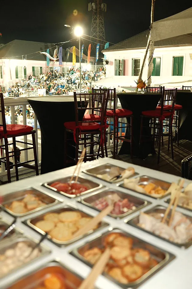 The charcuterie cart at an evening event under string lights